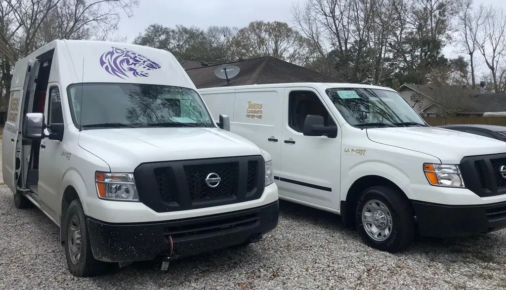 Two branded Tigers Locksmith service vans parked side by side